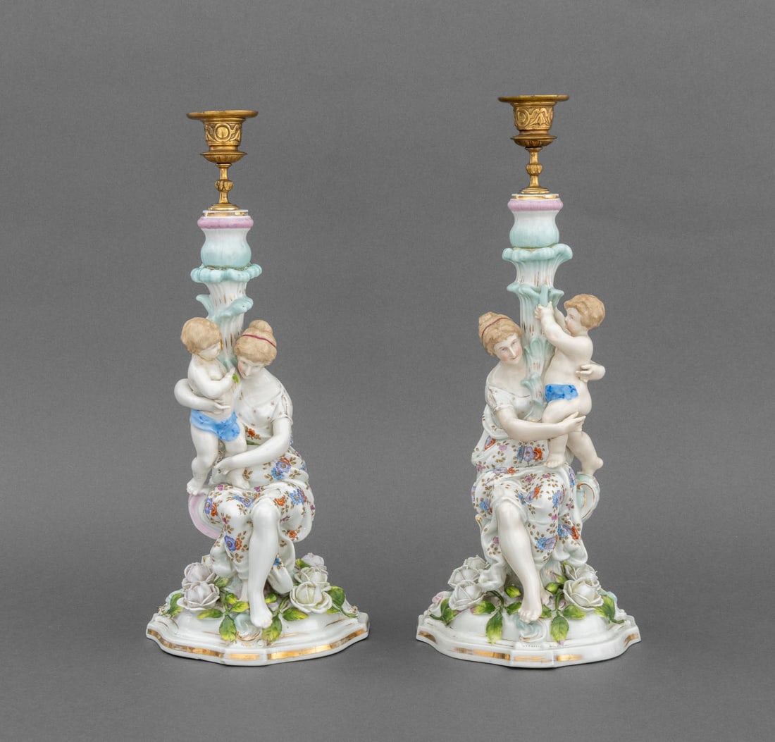 Meissen Style Porcelain Figural Candlesticks, Pair: Pair of Meissen Style Porcelain Figural Candlesticks, each in the form of a seated woman holding a child in rose garden, impressed crossed sword, "DKE", and "50" marks to underside. 16" H x 7.5" W x 7