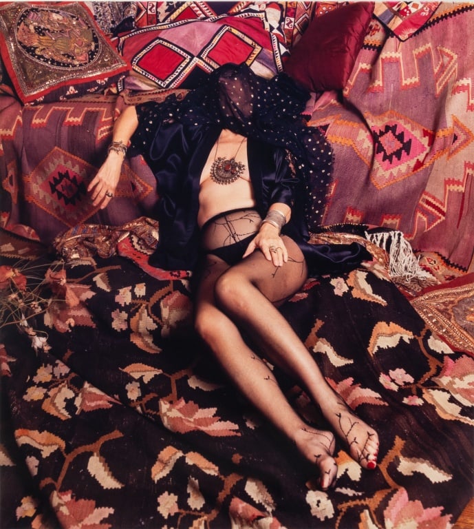 Anne Sager "Women Over 50" Chromogenic Print: Anne Sager (American, 1930-2024), Reclining Female Figure, Chromogenic Print in Colors on Kodak Paper, from the "Women Over 50" series, depicting a woman in lingerie lounging on richly patterned carpe