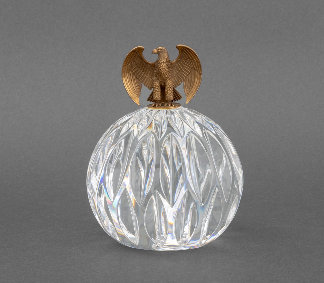 Steuben "Orb & Eagle" 18K Gold & Crystal Sculpture: Steuben "The Orb and Eagle" Sculpture, designed by James Houston, the 18K gold eagle mounted on cut-crystal orb, marked "18K" to eagle base and signed "Steuben" to underside. 5.75" H x 5" Diameter.