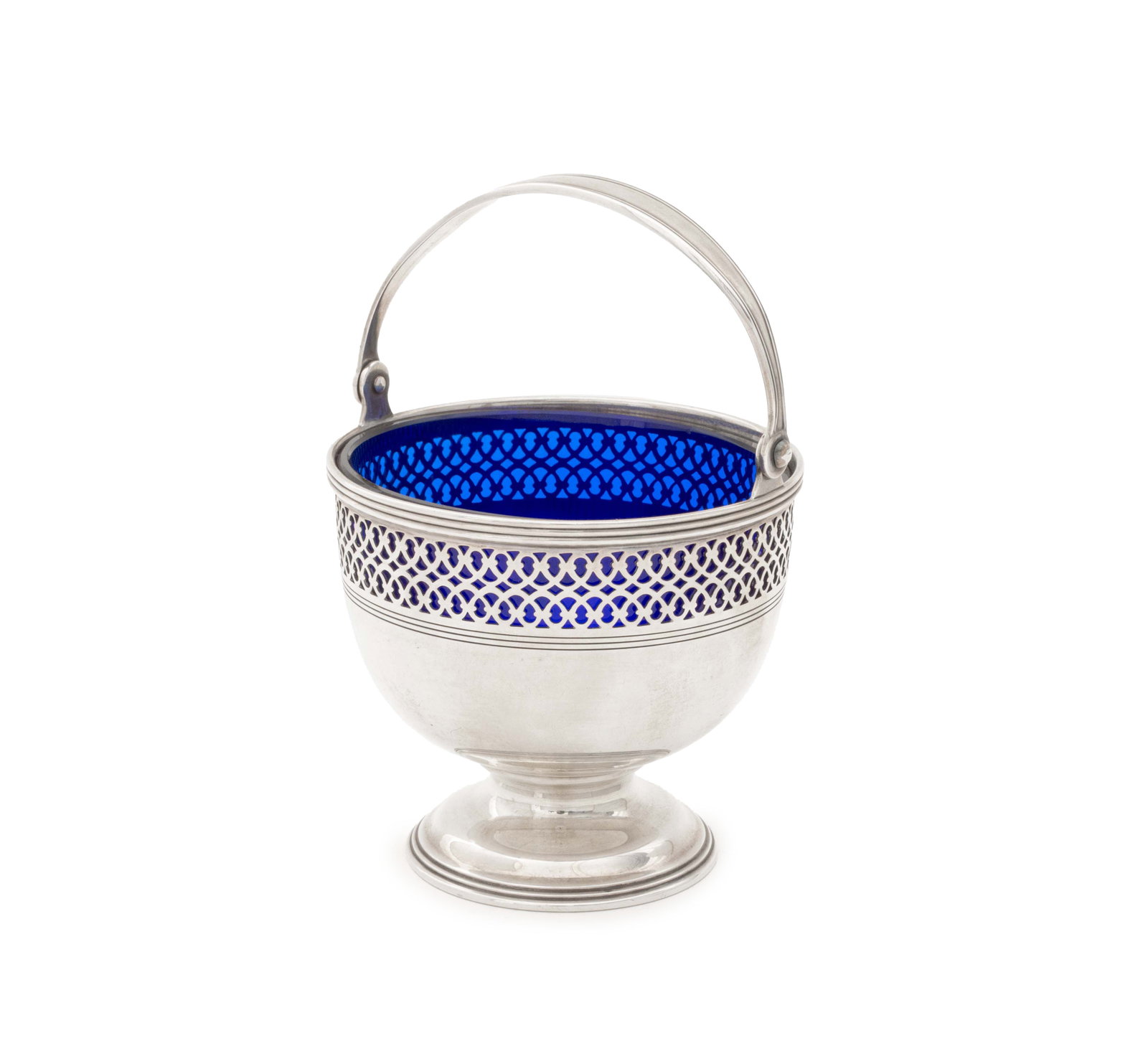 Tiffany & Co. Makers Sterling Pierced Basket: Tiffany and Company Makers Sterling Silver Pierced Basket, 1907-1947, with cobalt blue glass liner and swing handle, marked "Tiffany & Co. / 20427 K Makers 8865 / Sterling Silver / 925-1000/ M" to und