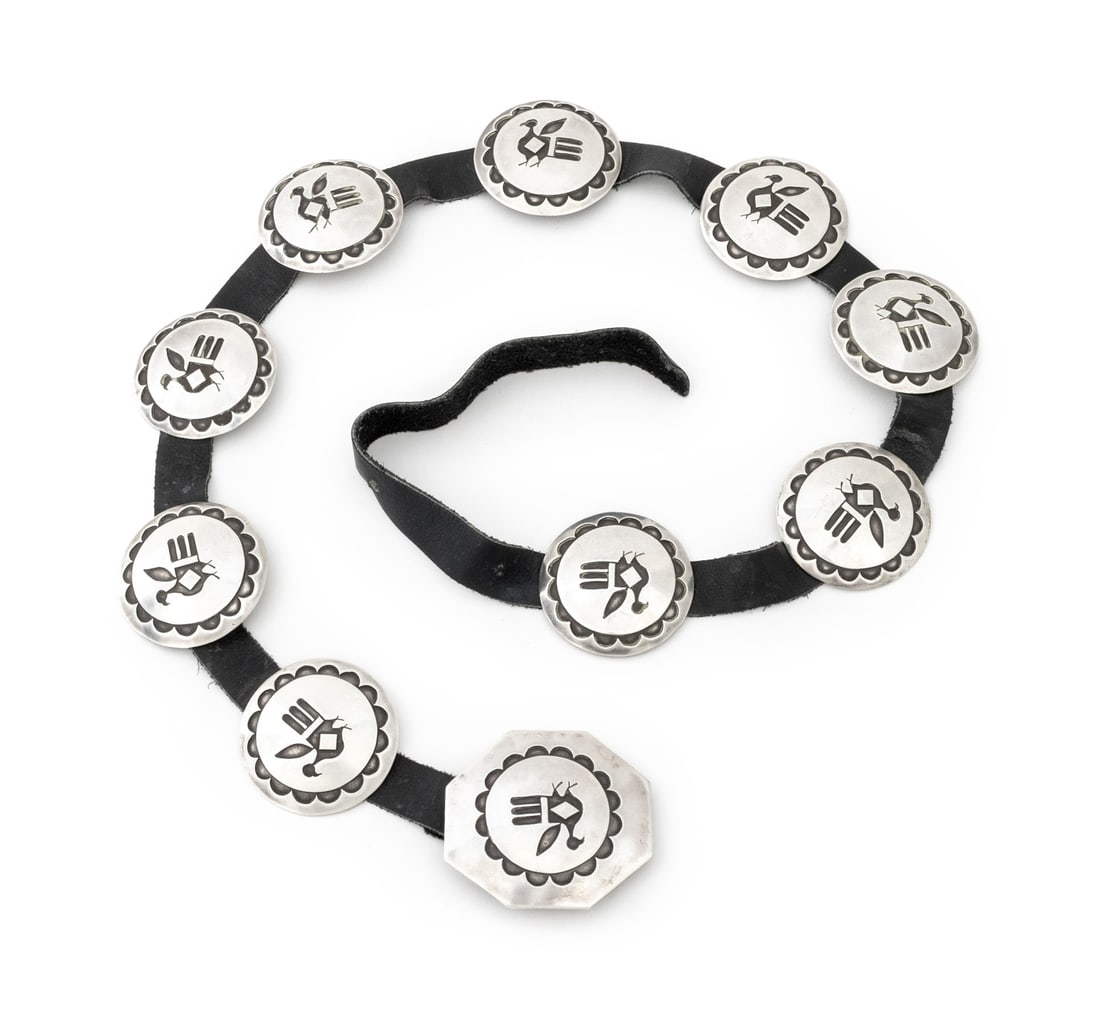 Hopi Thunderbird Motif Silver Leather Concho Belt: Hopi Thunderbird Motif Silver and Black Leather Concho Belt, with circular links and octagonal buckle, unmarked. Silver tested. Weight: 8.52 ozt.; 37" L x 2.25" W. Provenance: From the Collection of L