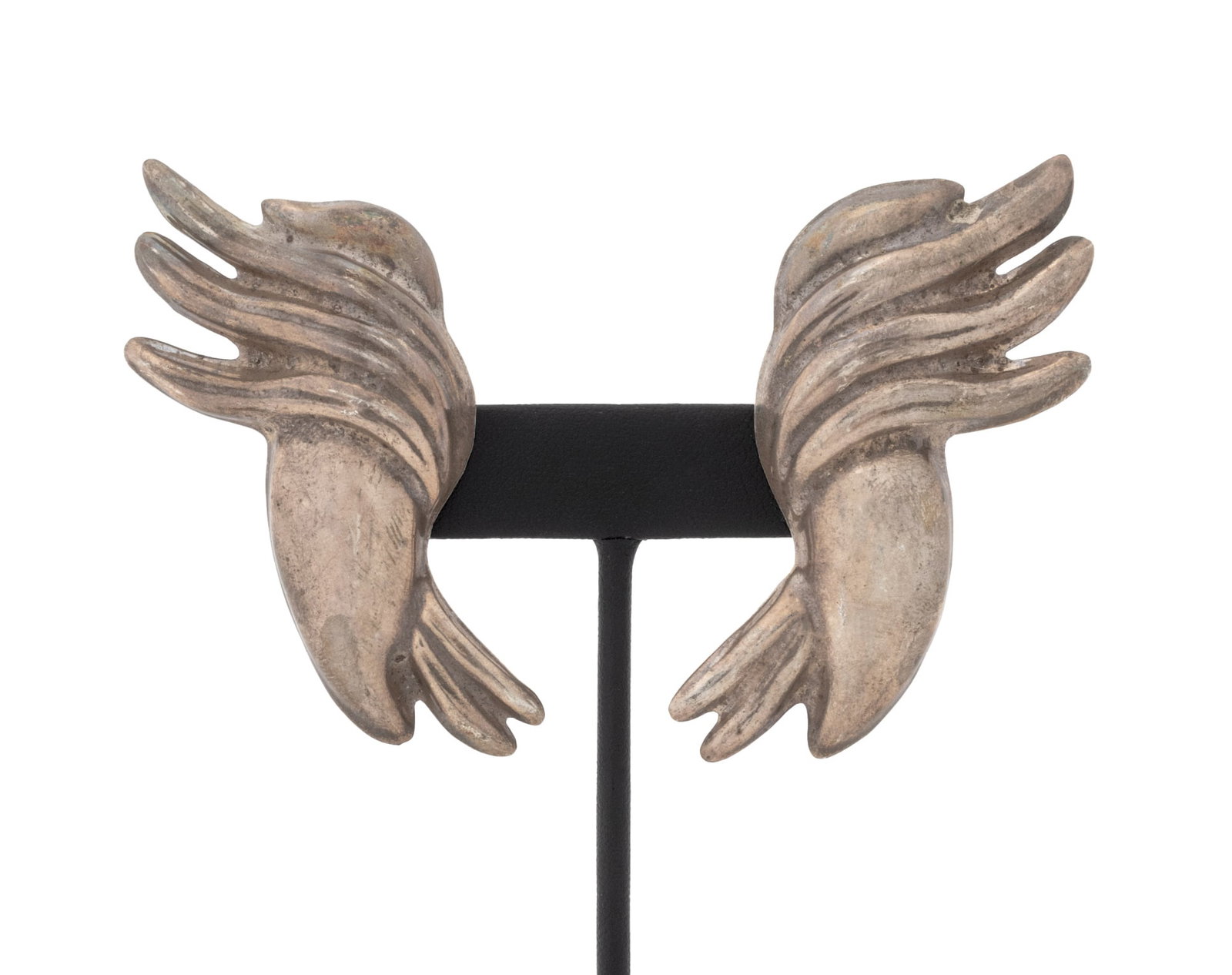 Mexican Sterling Silver Wing Earrings: Pair of Mexican Sterling Silver Wing Earrings, featuring brightly polished surfaces, worn on earlobes with with clip on lever backs, marked: "TD-82 925 Mexico". Measuring approx. 2 3/4" x 1 1/4", 0.77