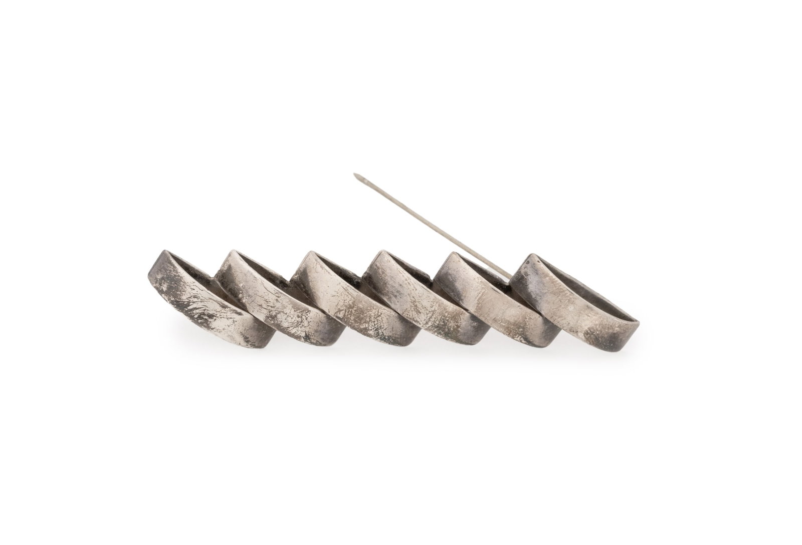 Mexican Sterling Silver Geometric Brooch: Mexican Sterling Silver Geometric Brooch, featuring brightly polished surfaces shaped as repeating half round arches fixed to one flat base, worn through fabric with pinstem, joint and catch, marked: 
