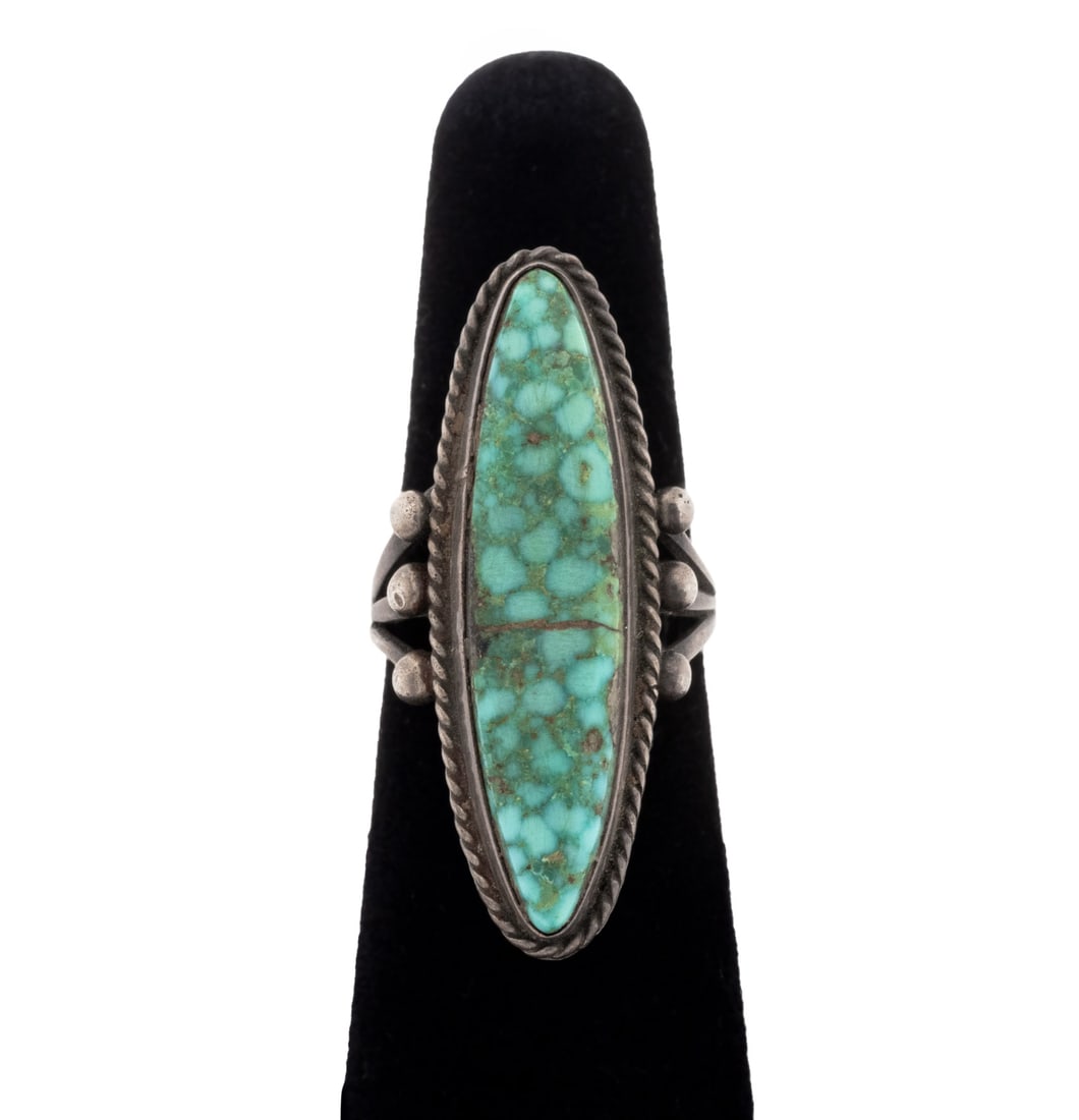 Native American 925 Silver Turquoise Long Ring: Native American Sterling Silver Turquoise Long Ring, featuring one bezel set navette turquoise cabochon weighing approx. 11.25 carats. Silver Tested. Measuring approx. US size 7, 0.25 ozt. Provenance: