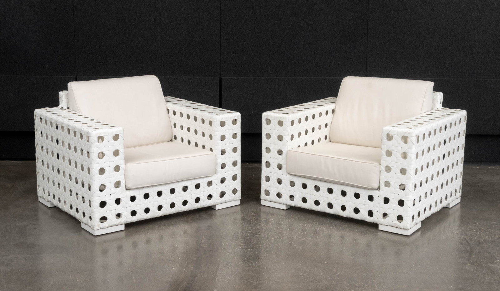 Skyline Design Lounge Chairs, Pair: Pair of Skyline Design Lounge Chairs, with white woven plastic frames and beige cushions. 36" H x 42" W x 36" D; seat: 17.5" H. Provenance: From a Warren, New Jersey Collection. Keywords: Patio Furnit