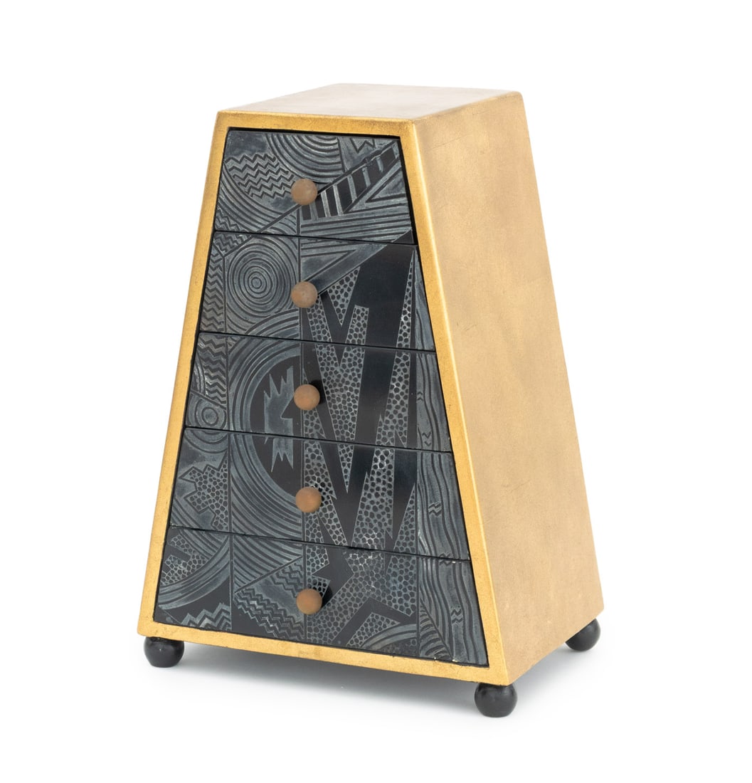 Postmodern Memphis Style Miniature Chest: Postmodern Memphis Style Gilt and Ebonized Wood Miniature Chest of Drawers, with carved abstract design on the five graduated drawers on four ball form feet. 17" H x 12" W x 8" D. Provenance: From a W