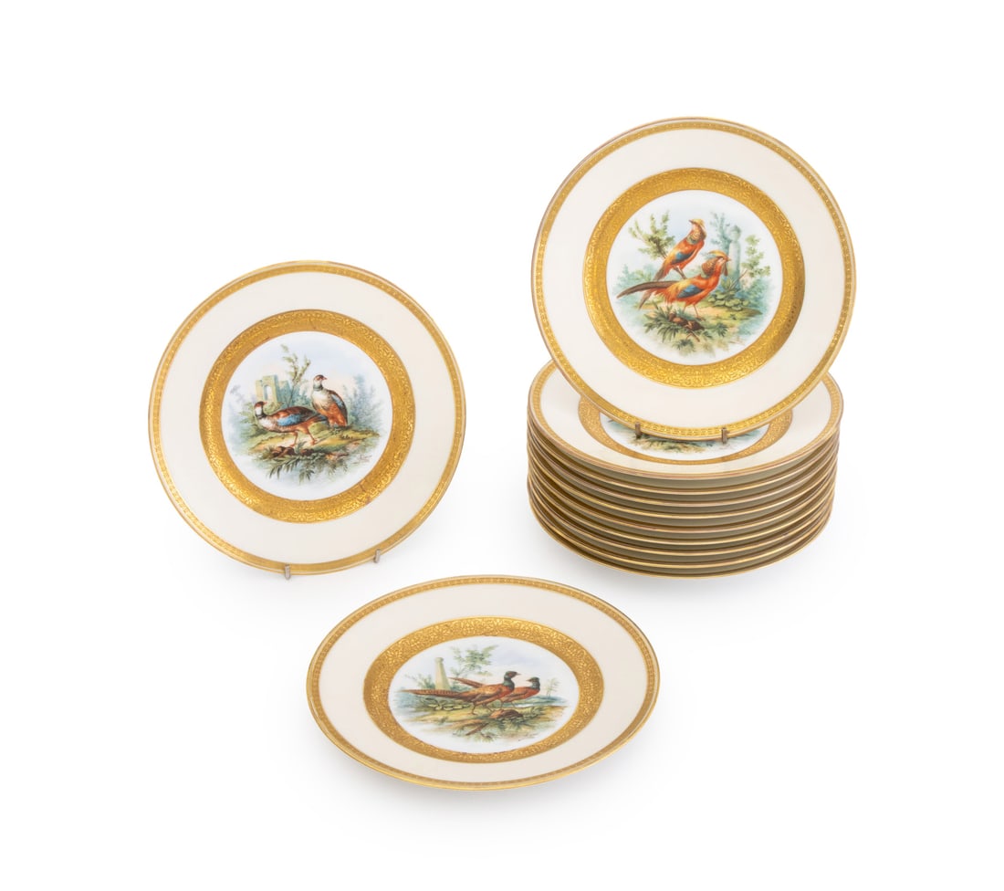 Richard Briggs French Porcelain Game Plates, 12: Set of Twelve Richard Briggs Boston French Porcelain Game Plates, each featuring a central hand-painted vignette of birds amongst a landscape scene signed "Audon" within gilt borders and marked "Fabri