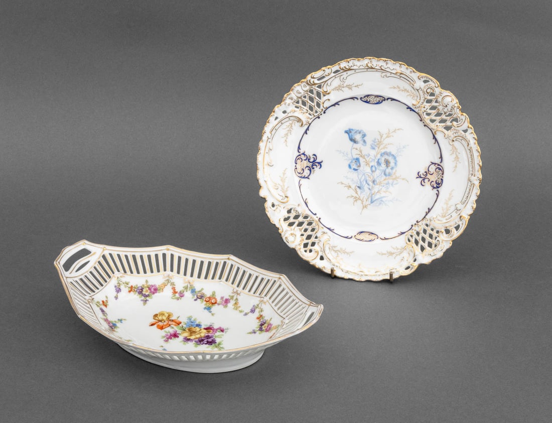 German Pierced Porcelain Tableware, 2 Pcs.: Two German Reticulated Porcelain Tableware Pieces, comprising: Bavarian Schumann floral and gilt basket, marked to underside and Dresden blue flower and gilt plate, marked to underside. Larger: 2.5"