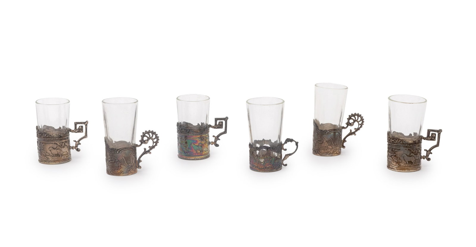 Victorian Sterling and Glass Cordial Glasses, 6: Collection of Six Victorian Sterling Silver and Clear Glass Cordial Shot Glasses, struck with marks for Berthold Muller & Son, Chester, 1899 and Hanau marks, with various repousse figural scenes and