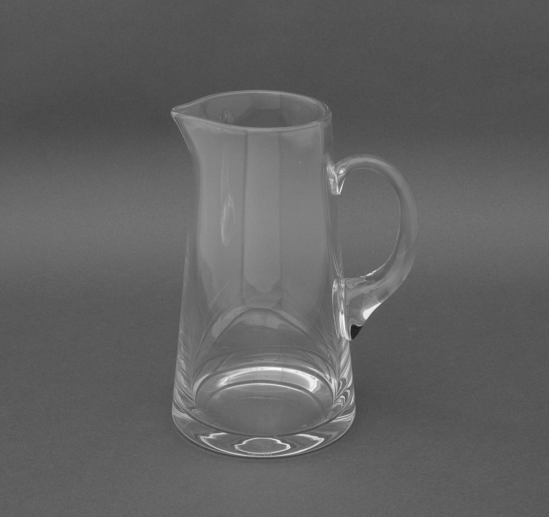 Tiffany & Co. Glass Cocktail Pitcher: Tiffany and Company Glass Cocktail Pitcher, marked "Tiffany & Co." to underside. 10.25" H x 8" W x 5.75" D. Provenance: The Estate of Gilbert C. Maurer, Director and Former COO of Hearst, Former
