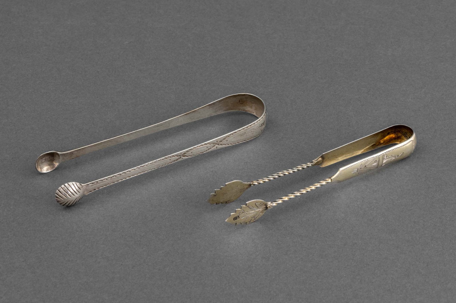 European Import Silver Sugar Tongs, 2: Group of Two European Import Silver Sugar Tongs, leaf-form grips with Russian Import left-facing kokoshnik mark and "AC", with Cyrillic initials to end, other Berthold Muller Hanau silver import, with