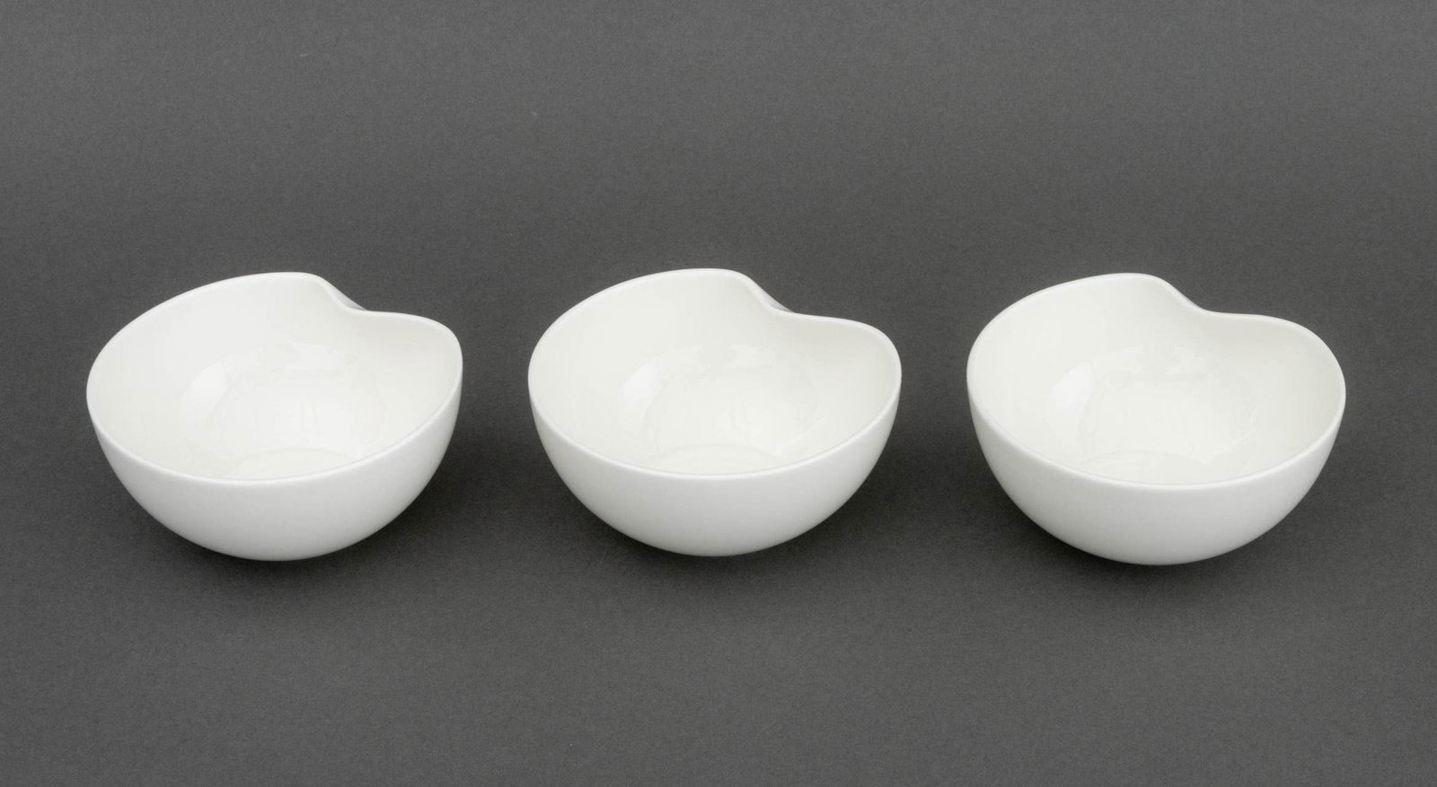 Elsa Peretti x Tiffany & Co. "Thumbprint" Bowls, 3: Set of Three Elsa Peretti for Tiffany & Co. Porcelain "Thumbprint" Bowls, marked to undersides. 2.25" H x 4.75" Diameter. Provenance: From a 45 Sutton Place South Estate. Keywords: Luxury goods, T&Co.