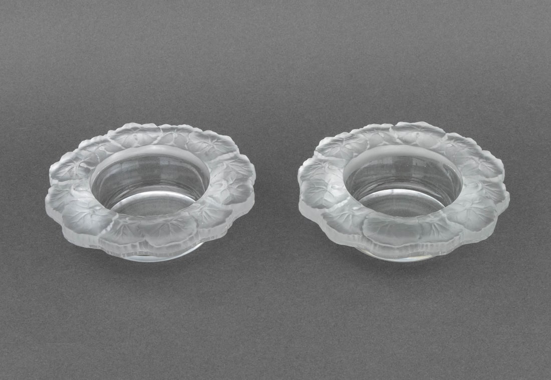 Lalique "Honfleur" Style Bottle Coasters, Pair: Pair of Lalique "Honfleur" Style Clear and Frosted Glass Wine Bottle Coasters, unmarked. 6.5" Diameter x 2" H. Provenance: From a Connecticut Estate. Keywords: Oenology, Art Glass, Geranium leaf,
