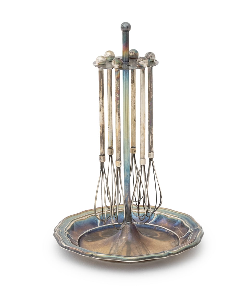 Silver Plate Champagne Swizzle Sticks on Stand: Set of Six Silver Plate Champagne Swizzle Sticks on Stand, the stand with floriform base. Overall: 6.25" H x 4" Diameter. Provenance: From a West End Avenue Collection. Keywords: Oenology, Champagne