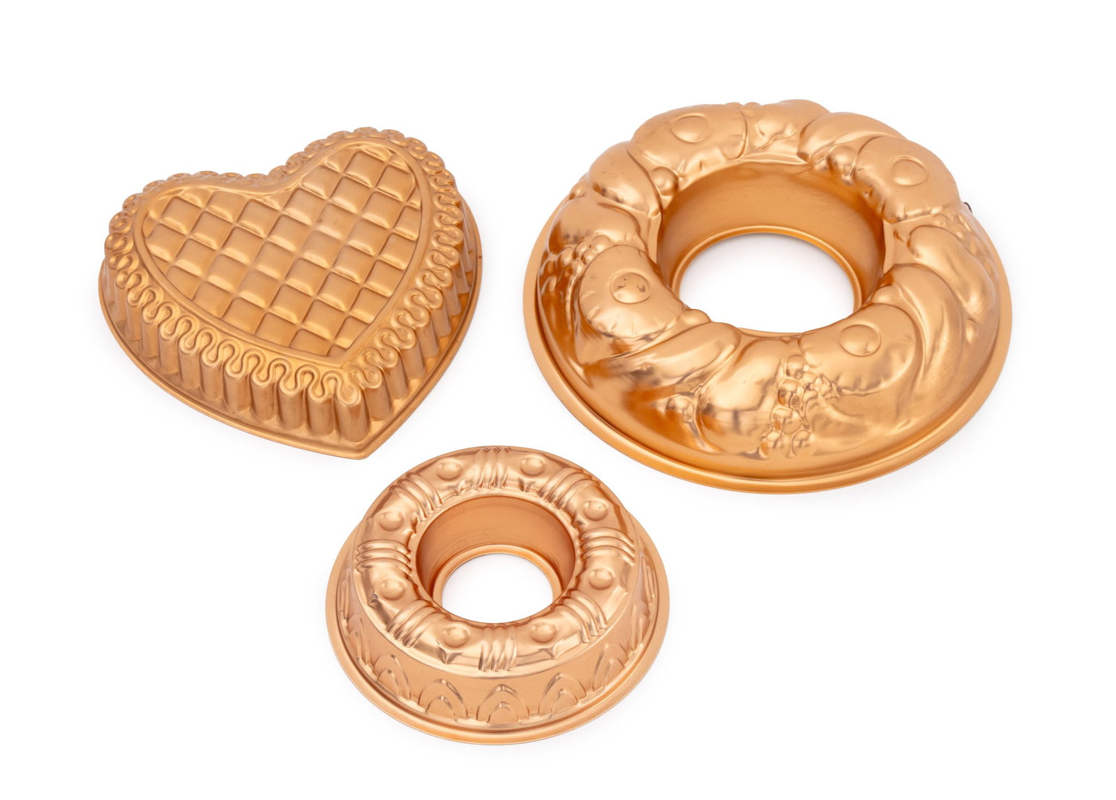 Vintage Copper Cake Pans, 3: Group of Three Vintage Copper Cake Pan Molds, comprising: (2) two ring form and (1) one heart form. Largest: 3" H x 13.25" Diameter. Provenance: From a Connecticut Estate. Keywords: Jelly Molds, Cookw