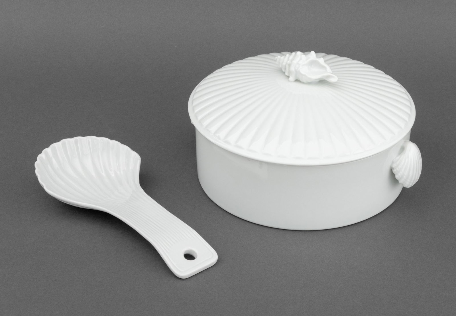 Shell Form Porcelain Covered Soup Tureen and Spoon: Shell Form Porcelain Covered Soup Tureen and Spoon, with shell handles and knop. Tureen: 5.25" H x 10" W x 9" D. Provenance: From a Westchester County Estate. Keywords: Ceramics, Tableware, Dining, Se
