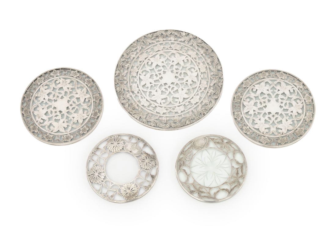 American Silver & Glass Circular Trivets, 5: Group of Five American Sterling Silver and Glass Circular Trivets, with floral pierced overlay, three marked "Webster / Sterling" to the side and two with obliterated marks to the side. Silver tested 