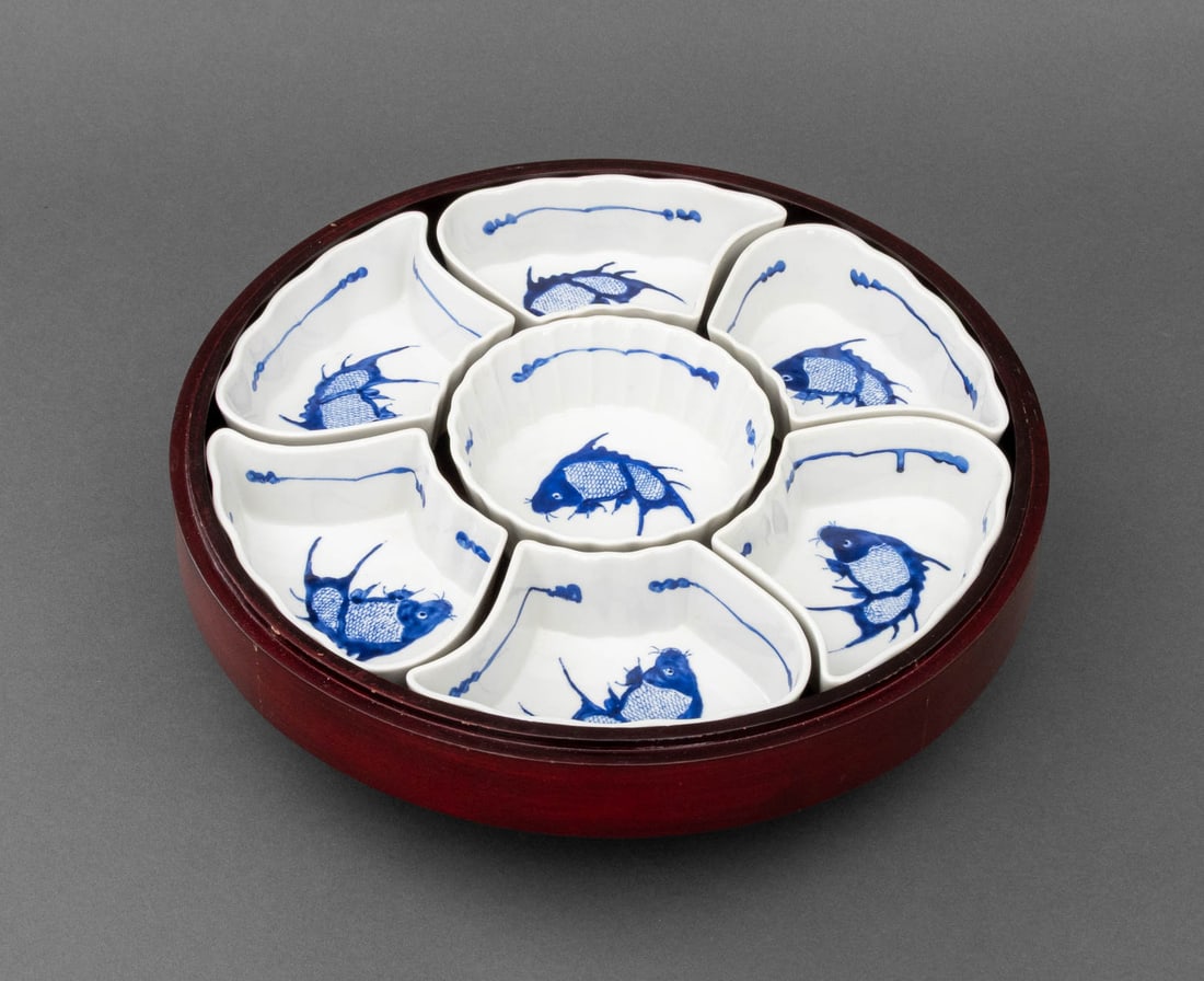 Chinese Seven-Piece Sweet Meat Set in Case: Chinese Seven-Piece Porcelain Sweet Meat Set in Case, the dishes decorated with fish designs, the footed circular wood box on turntable. Center dish: 1.5" H x 4.75" Diameter; Case: 4.5" H x 13" Diamet