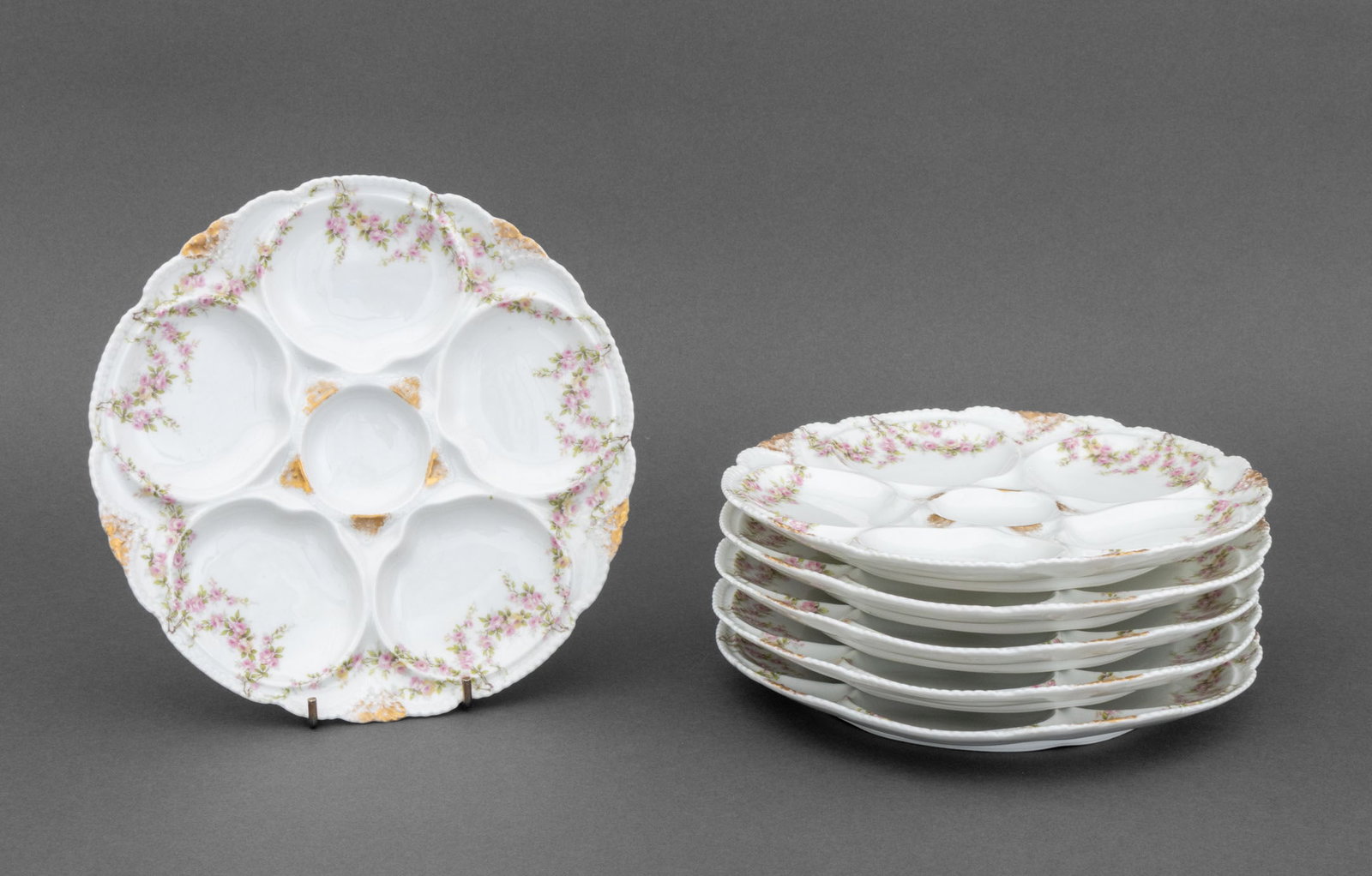 Theo Haviland Porcelain Oyster Plates, 6: Set of Six Theo Haviland Porcelain Oyster Plates, each with pink roses and gilt accents and marked "Porcelaine Theo Haviland Limoges France" with impressed "T H" mark to underside. 8.5" Diameter x