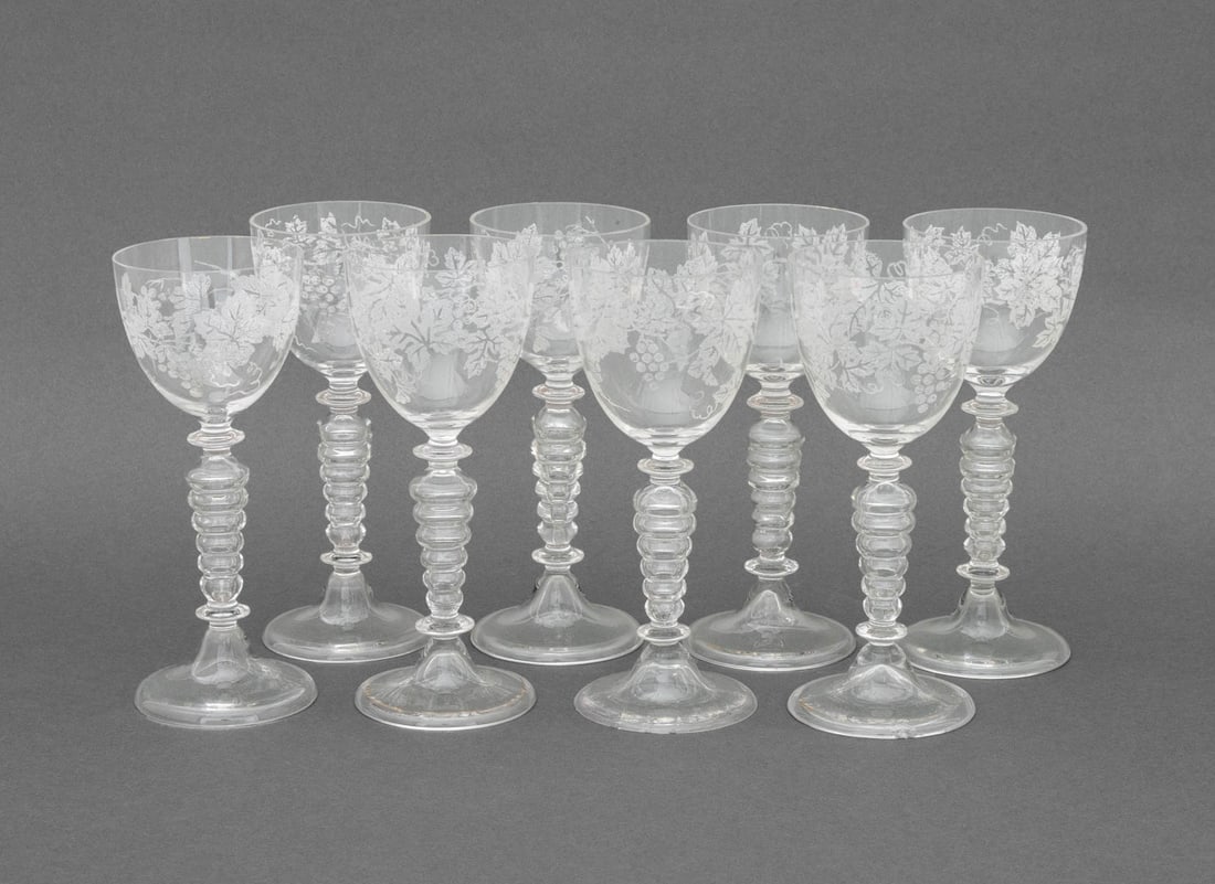 Grapevine Motif Etched Crystal Glasses, 8: Set of Eight Grapevine Motif Etched Crystal Glasses, with graduated orb form stems. 6.5" H x 2.75" Diameter. Provenance: The Estate of Alton G. Marshall, former aide to Nelson Rockefeller and