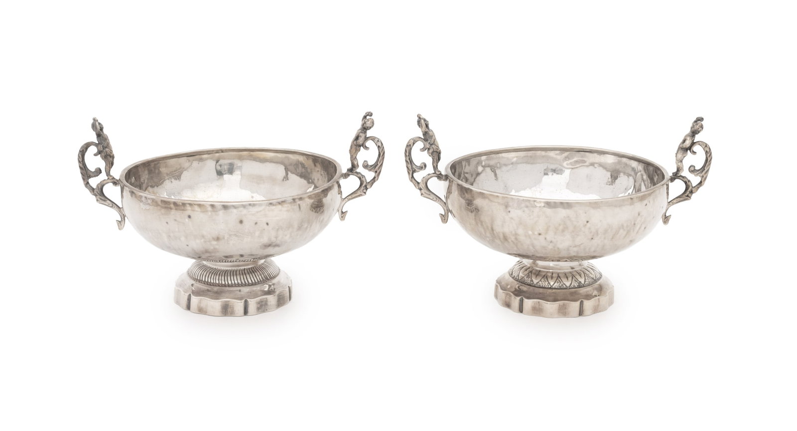 Putti Motif Silver Plate Brandy Bowls, Pair: Pair of Putti Motif Silver Plate Brandy Wine Bowls, each with two cherub form handles and raised on a floriform foot. 5.25" H x 8.25" W x 6" D. Provenance: From a Brooklyn Heights Townhouse.