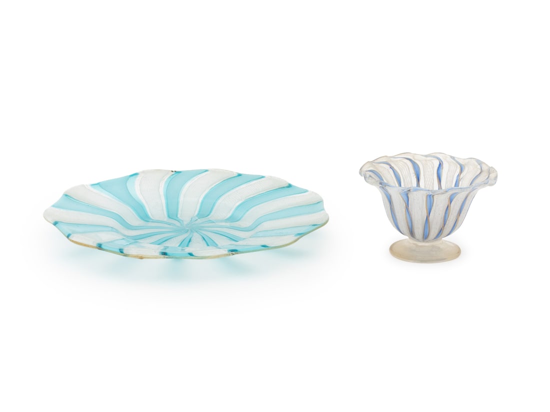 Murano Latticino Glass Tableware, 2 Pcs.: Two Murano Latticino Glass Tableware Pieces, in blue and white, comprising: one plate with scalloped rim and one footed cup with scalloped rim, unmarked. Larger: 7.25" Diameter. Provenance: The Estate