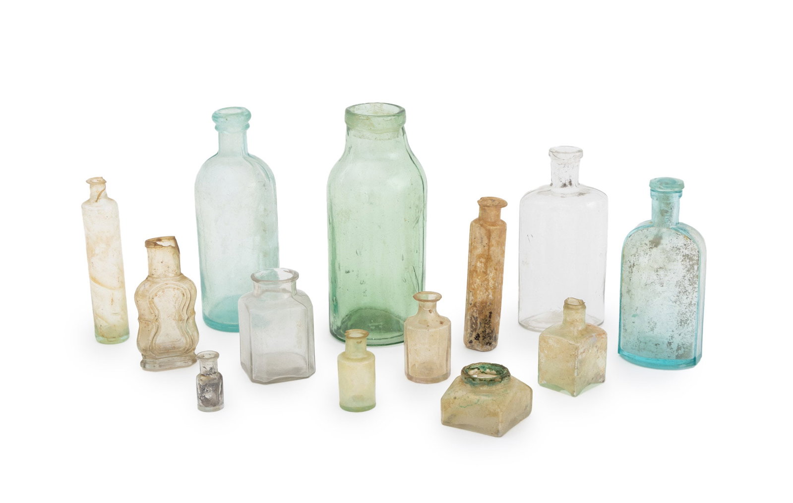 Vintage & Antique Apothecary Glass Bottles, 13: Collection of 13 Antique and Vintage Apothecary Glass Bottles. Largest: 7.5" H x 3.25" Diameter. Provenance: From the Estate of Joseph Lawrence Gardella. Keywords: Glassware, Vessel, Container, Collec
