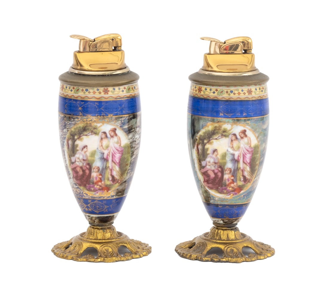 French Porcelain Table Lighters, Pair: Pair of French Gilt Metal Mounted Porcelain Table Lighters, each with classical figure vignette. 6.5" H x 3" Diameter. Provenance: From a West End Avenue Collection. Keywords: Smoking accessories,
