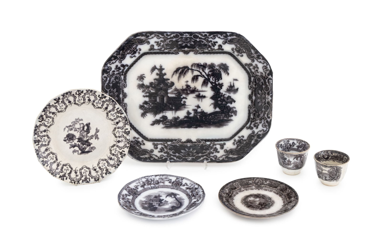 British Black & White Ironstone Tableware, 6 Pcs.: Group of Six British Black and White Ironstone Tableware Pieces, comprising: (1) one serving platter in Coram pattern, (2) two Cyprus patterns, one dessert plate and (1) one teacups, (1) one salad