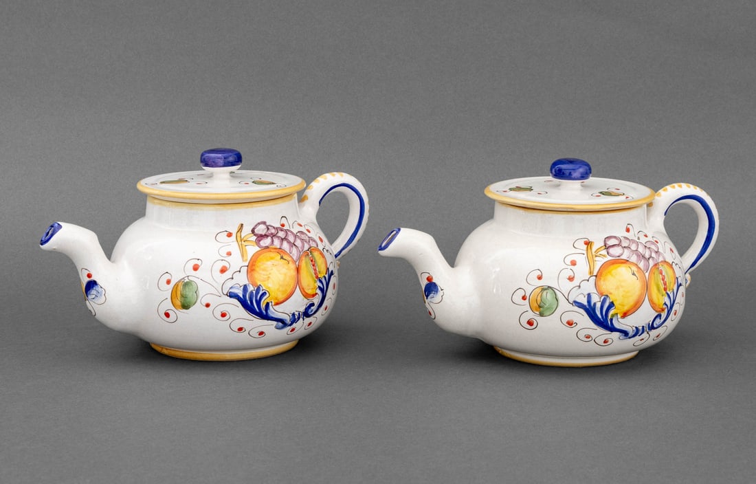 Italian Maiolica Fruit Motif Teapots, 2: Group of Two Italian Maiolica Teapots, each marked "Deruta" to underside. 5.5" H x 10.5" W x 6.5" D. Provenance: From a Warren Collection. Keywords: Majolica, Art Pottery, Studio Pottery, Italian