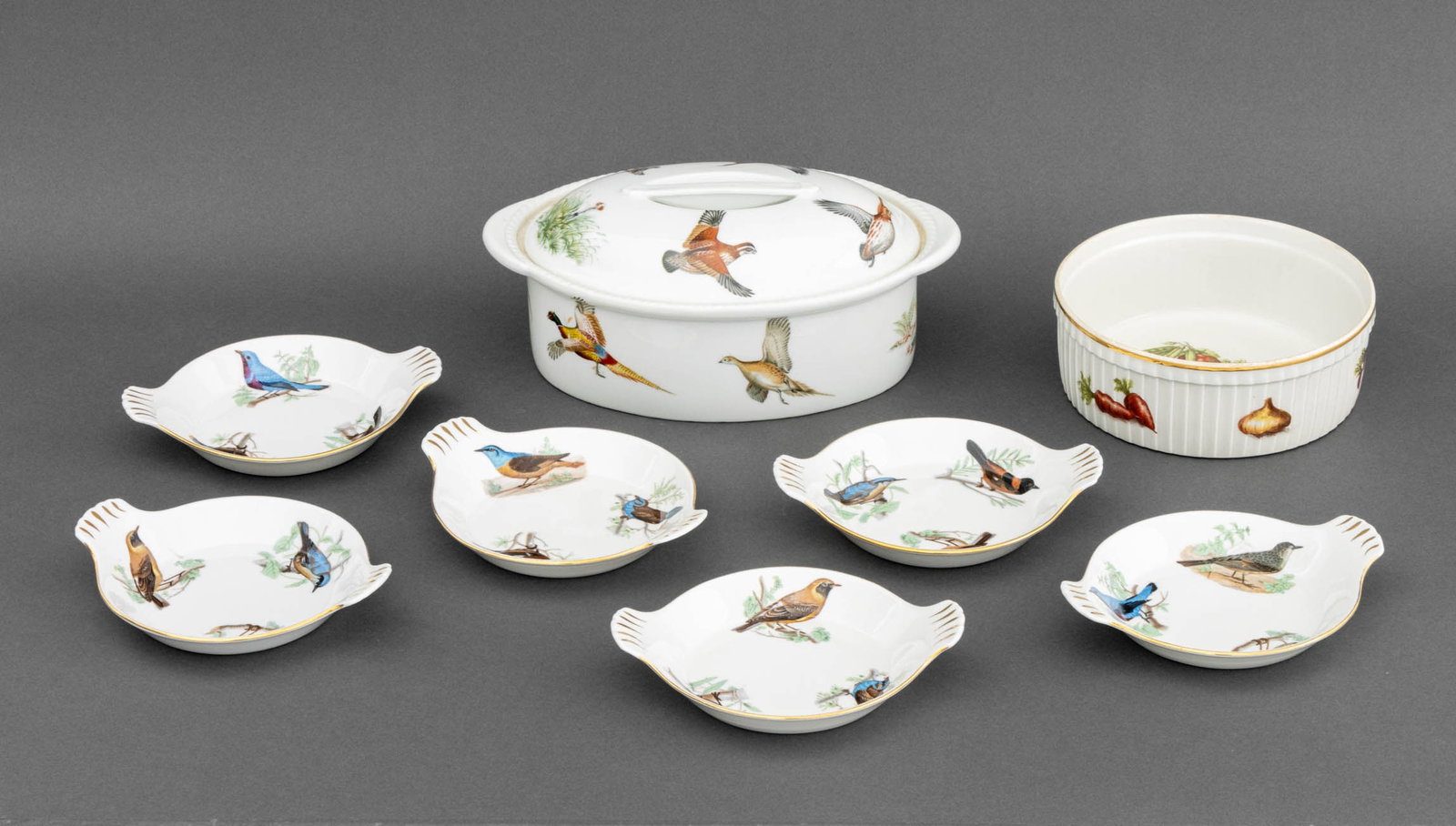 French Limoges Porcelain Tableware, 8 Pcs.: Group of French Limoges Porcelain Tableware Pieces, comprising: (1) one covered tureen with bird motif, (1) one circular bowl with vegetable motif, and (6) six Louis Lourioux "Le Faune" au gratin