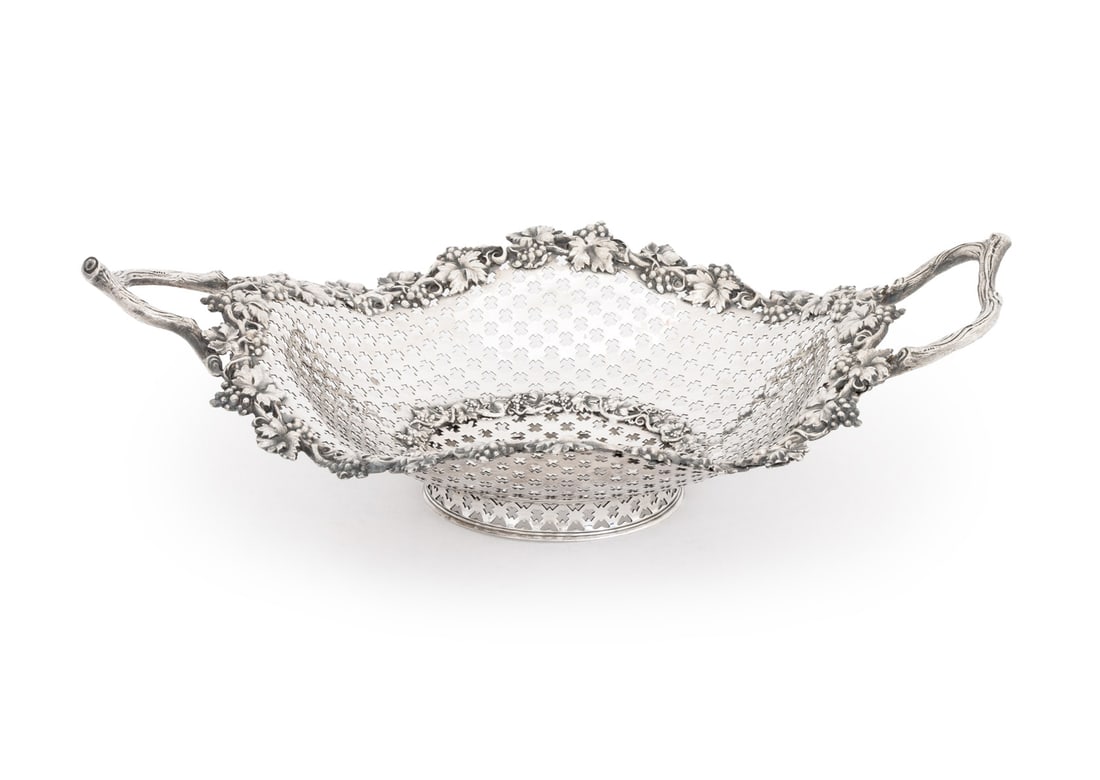 Victorian Silver Plate Reticulated Basket: Victorian Silver Plate Pierced Basket, with two branch form handles and grapevine motif rims, unmarked. 4.5" H x 15" W x 9" D. Provenance: The Estate of Alton G. Marshall, former aide to Nelson Rockef