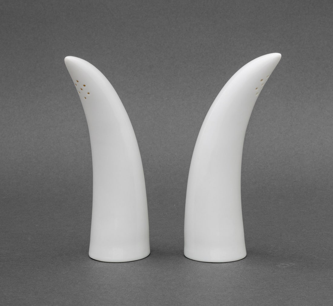 Modernist Tusk Form Salt and Pepper Shakers, Pair: Pair of Modernist Tusk Form Salt and Pepper Shakers, white ceramic, apparently unsigned. 6.25" H x 1.75" W x 2.75" D. Provenance: From the Estate of Gerard Stora, Vice President of Wildenstein Gallery