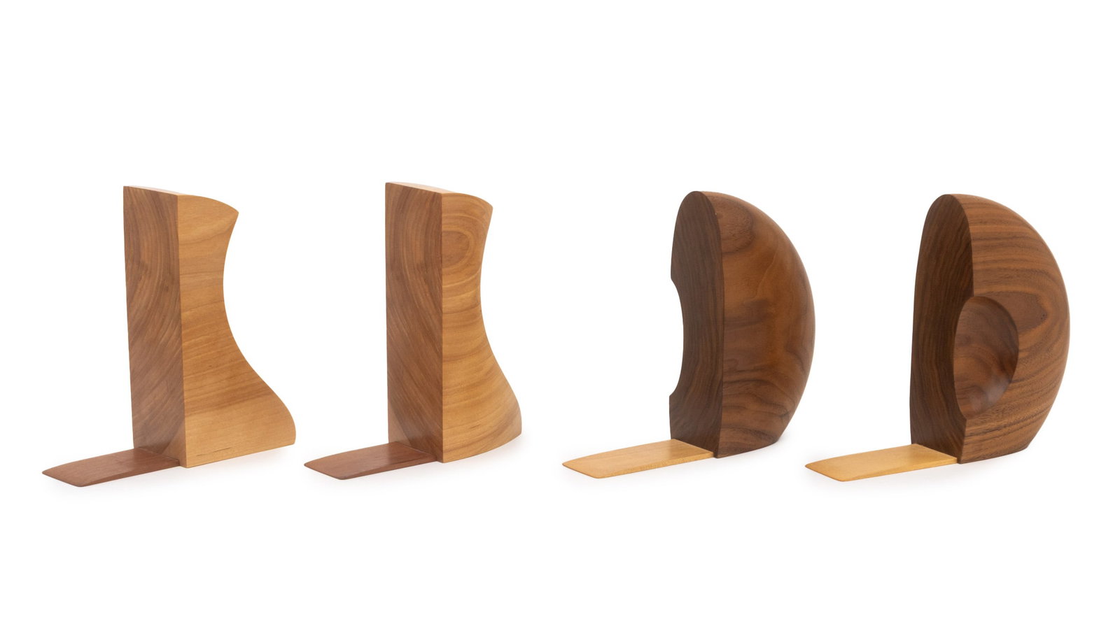 Peter Bloch Carved Wood Bookends, 2 Pairs: Peter Bloch (American, XX-XXI) Two Pairs of Carved Wood Bookends, both signed and marked "Handmade in New Hampshire", one pair white birch and one pair black walnut. Each taller: 7.75" H x 2.75" W x 7