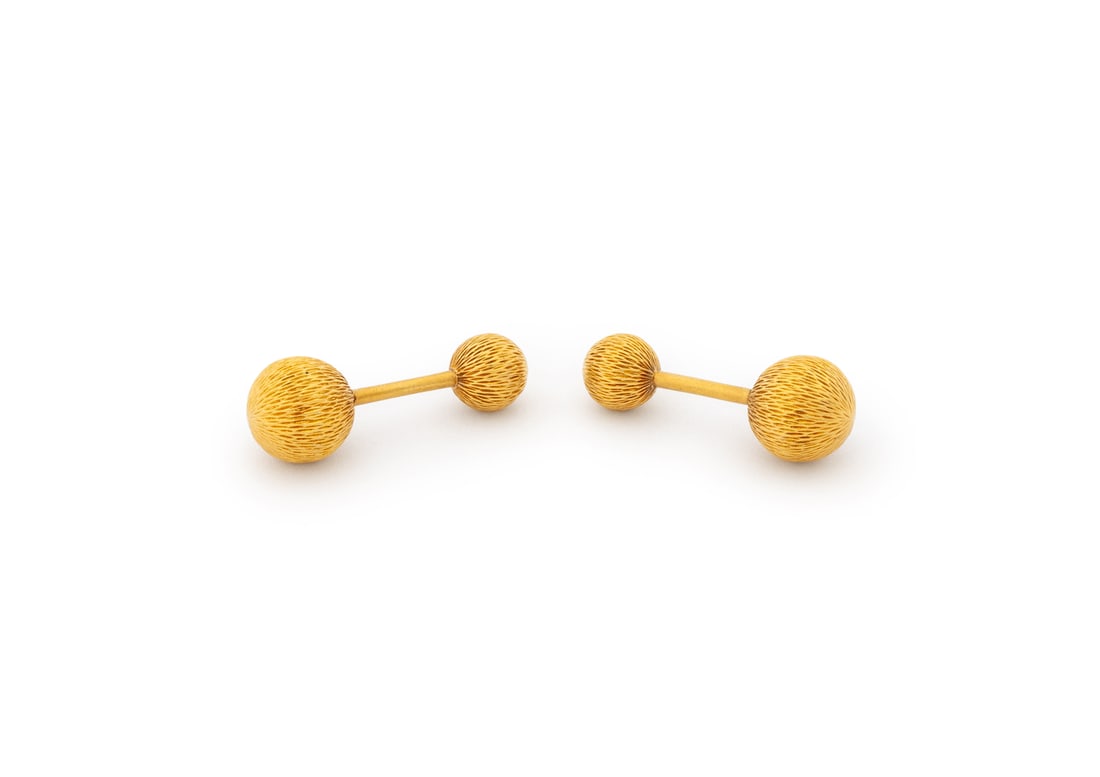 Tiffany & Co. 18K Yellow Gold Cufflinks: Pair of Tiffany and Company 18K Yellow Gold Cufflinks, brightly polished and fluted, designed as barbell style cufflinks approx. 12 mm tops and 9 mm bottoms, worn through French cuffs with fixed bar c