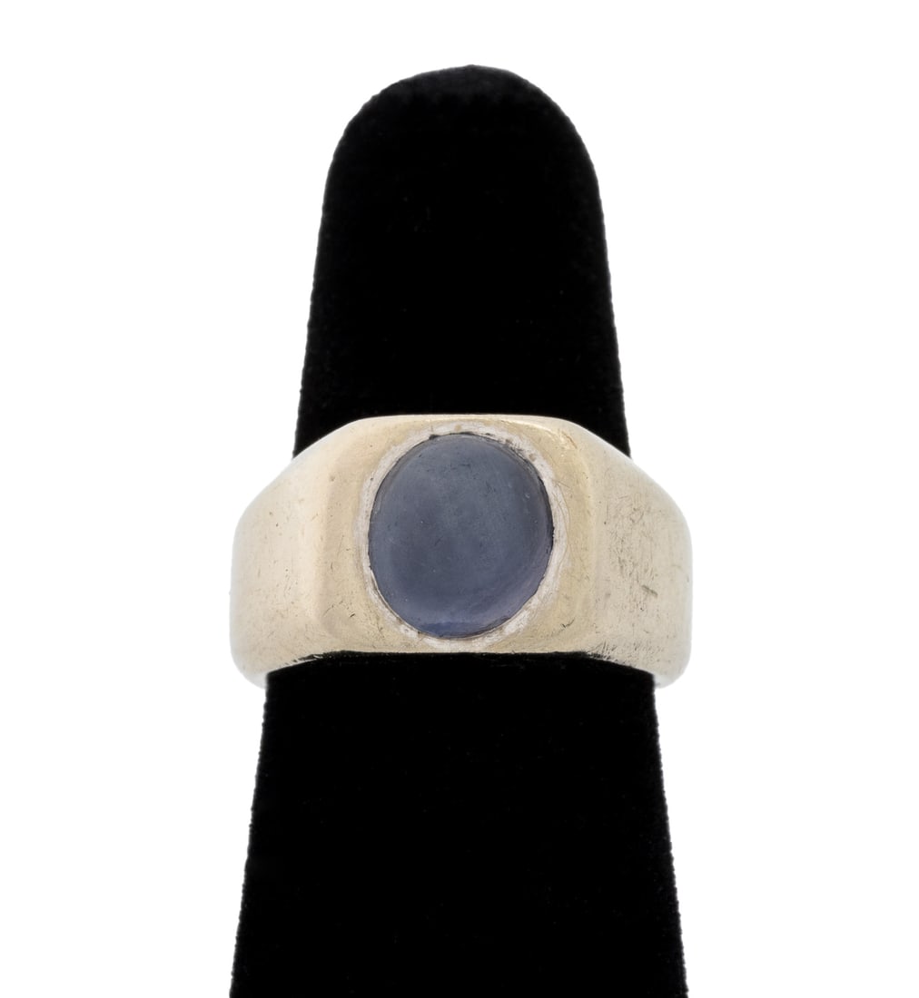 Modernist Star Sapphire White Gold Ring: Modernist Star Sapphire 14K White Gold Ring, featuring one flush set purple star sapphire cabochon weighing approx. 3.65 carats. Gold tested. Measuring approx. US size 5, 6.9 dwt. Provenance: From a 6