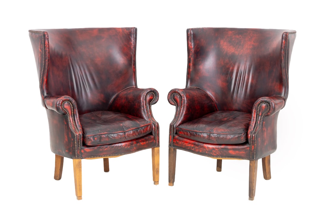 Red Vinyl Upholstered Wingback Armchairs, Pair: Pair of Red Vinyl Upholstered Wingback Arm Chairs, with riveted nailhead details. 44.5" H x 31.5" W x 35" D; seat: 18" H. Provenance: From the Collection of Laura and Lewis Kruger. Keywords: Vintage F