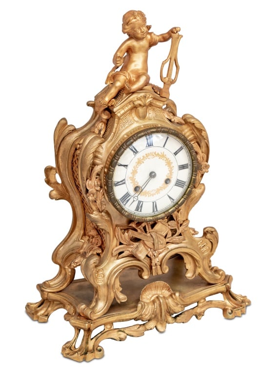 Louis XV Style Gilt Bronze Mantel Clock, 19th C.: Louis XV Style Gilt Bronze Mantle Clock, late 19th century, the circular dial surmounted by a cherub playing a harp, the movement strike on bell, on an integral scrolled base. 18.5" H x 12" W x 6.5" D