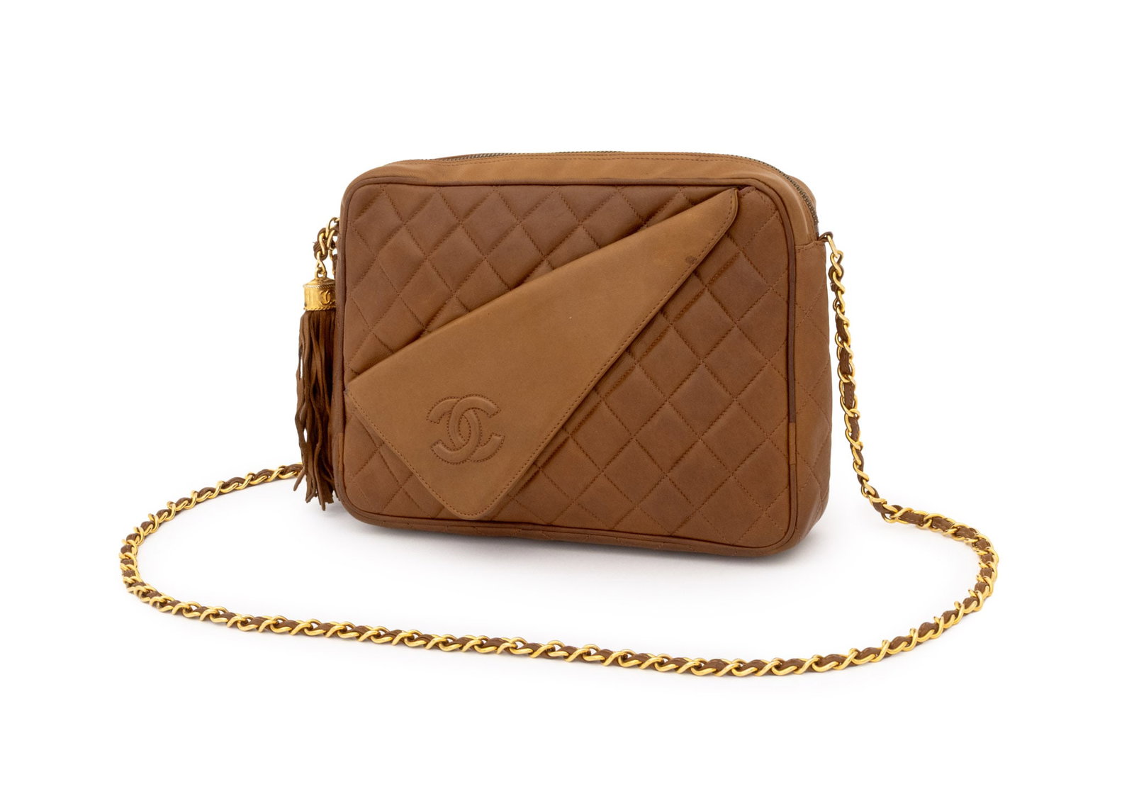 Chanel Quilted Brown Lambskin Camera Bag: Chanel Quilted Brown Lambskin Camera Bag, 1990s, with asymmetrical front pocket, gold-tone metal chain wrapped leather strap and tassel with CC monogram to the front, top zipper opening to red leather