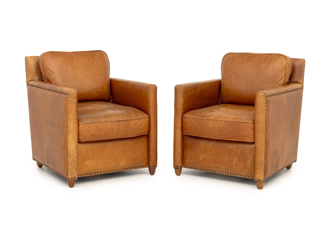 Revelation Tan Leather Club Chairs, Pair: Pair of Revelation Tan Leather Club Chairs, with riveted details, "Revelation" label to seat. 31" H x 26" W x 30.5" D; seat: 18" H. Provenance: From an Upper East Side Townhouse. Keywords: Modern Furn