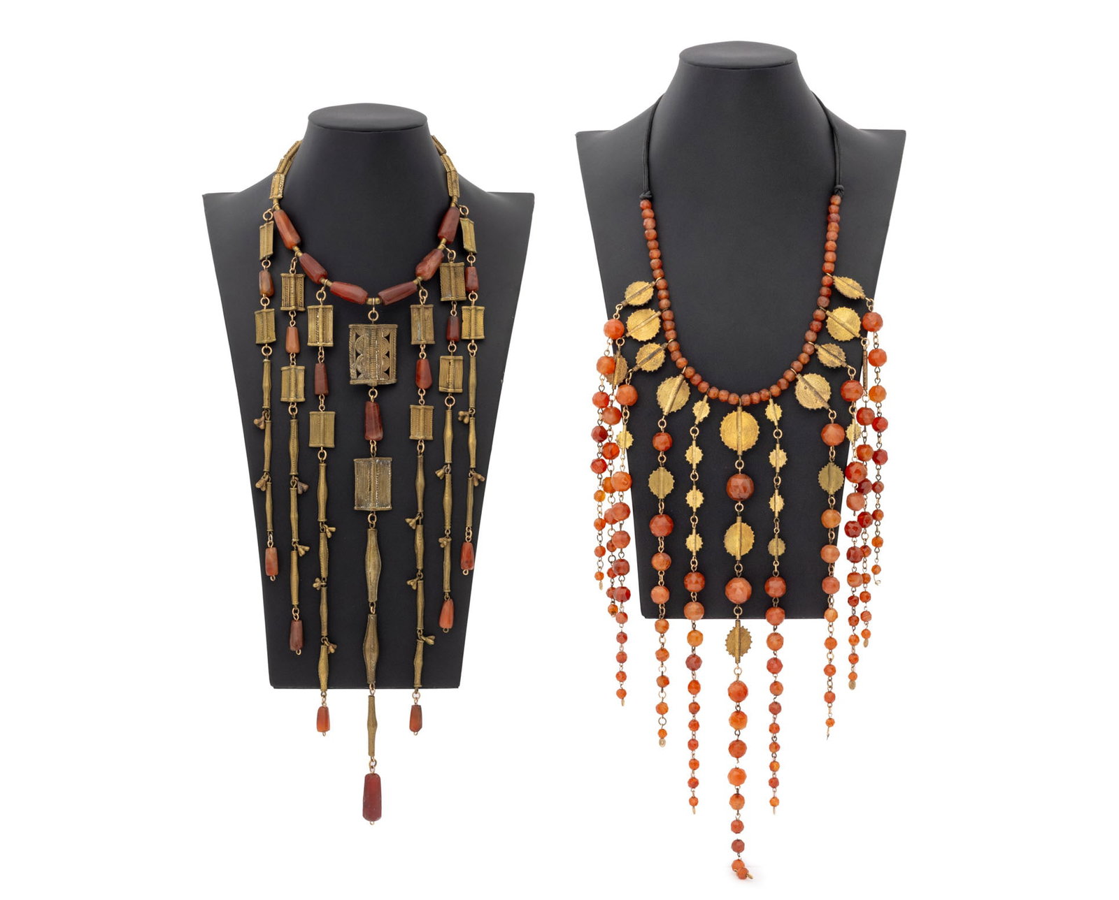 Irena Corwin Carnelian Art Jewelry Necklaces, 2: Irena Corwin (American, XX) Group of Two Carnelian Art Jewelry Necklaces, both with gilt metal and brass African pendants, one with hook eye clasp closure and one with silk cord. Longer: 20" L x 17.5"