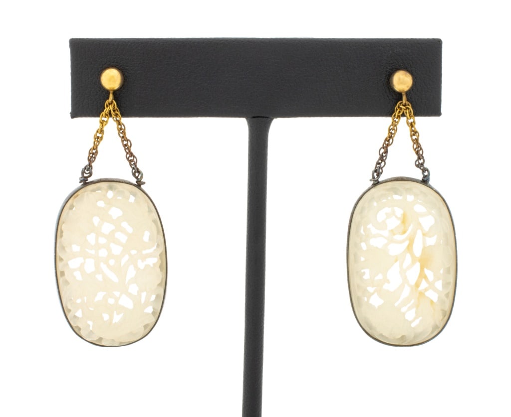 Chinese Carved White Jade Drop Earrings: Pair of Chinese 14K Yellow Gold and Sterling Silver Bezel Set Floral Lace Cut Carved White Nephrite Medallion Earrings, worn on the ear with pin-set post and clutch. Measuring approx. 1 3/4" x 3/4"; d