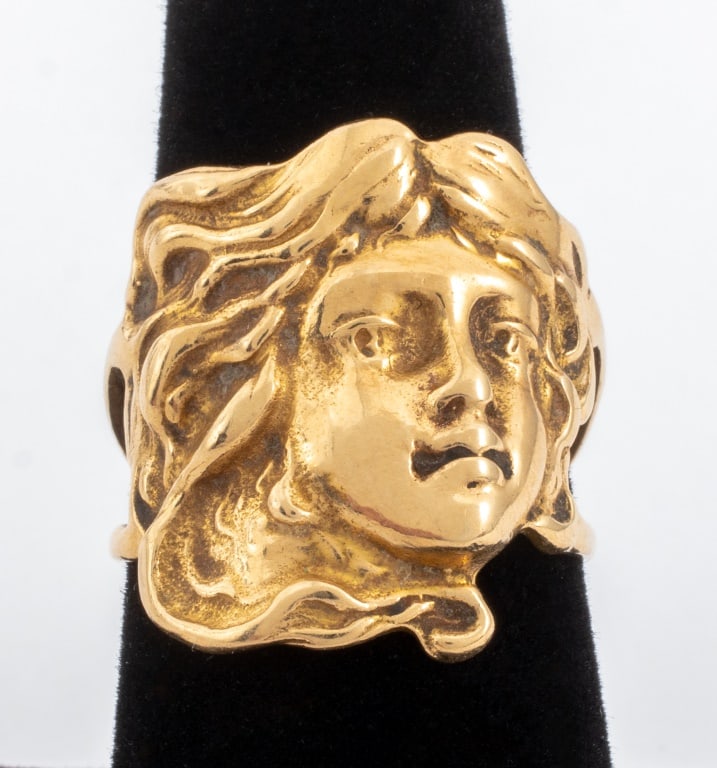 Art Nouveau Woman Masque Yellow Gold Ring: Art Nouveau Woman Masque 14K Yellow Gold Ring, brightly polished, designed as a female face with flowing hair, in the Art Nouveau creative style, marked: "14K". Measuring US size 8, 7/8" across the wi