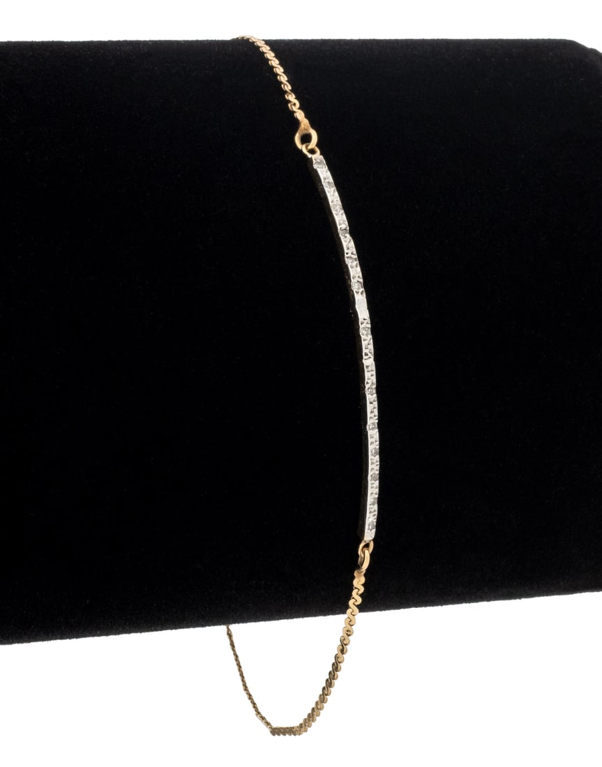 Diamonds and Yellow Gold Bar Bracelet: 14K Yellow Gold Diamond Bar Bracelet, featuring one diamond adorned bar with thirteen pave set round faceted diamonds weighing a total of approx. 0.07 carat, joined by two fixed serpentine link chains
