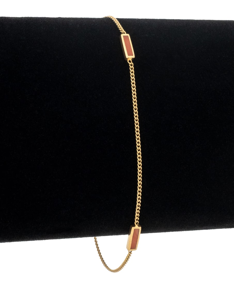 Red Coral and 18K Yellow Gold Station Bracelet: Red Coral and 18K Yellow Gold Station Bracelet. Gold tested. Measuring approx. 7" x 1/8", 1.0 dwt. Provenance: From the Estate of Gerard J. Stora. Keywords: Jewelry, Fashion, Accessories