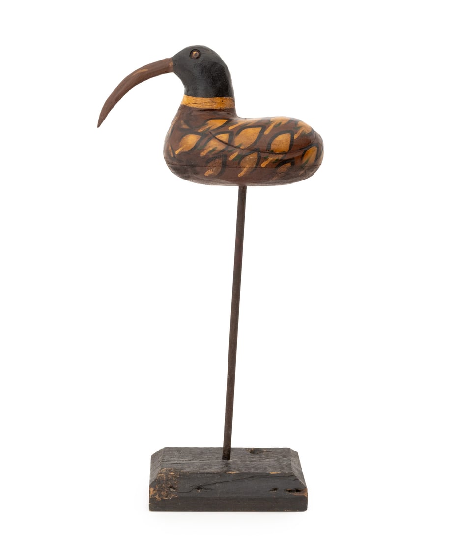 American Polychromed Wood Shorebird Decoy, c. 1900: American Polychrome Painted Wood Shore Bird Decoy, circa 1900, mounted on an iron pole atop an ebonized wood plinth. Overall: 26.75" H x 13" W x 6" D. Provenance: From a 21 East 87th Street Estate. Ke