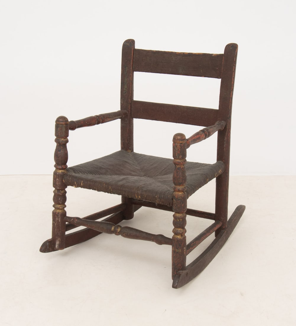 American Rush Seat Child's Chair, 19th C.: American Rush Seat Children's Rocking Chair, 19th century, with red painted wood frame. 18.5" H x 13.5" W x 17.75" D; seat: 8" H. Provenance: From a 21 East 87th Street Estate. Keywords: Americana,