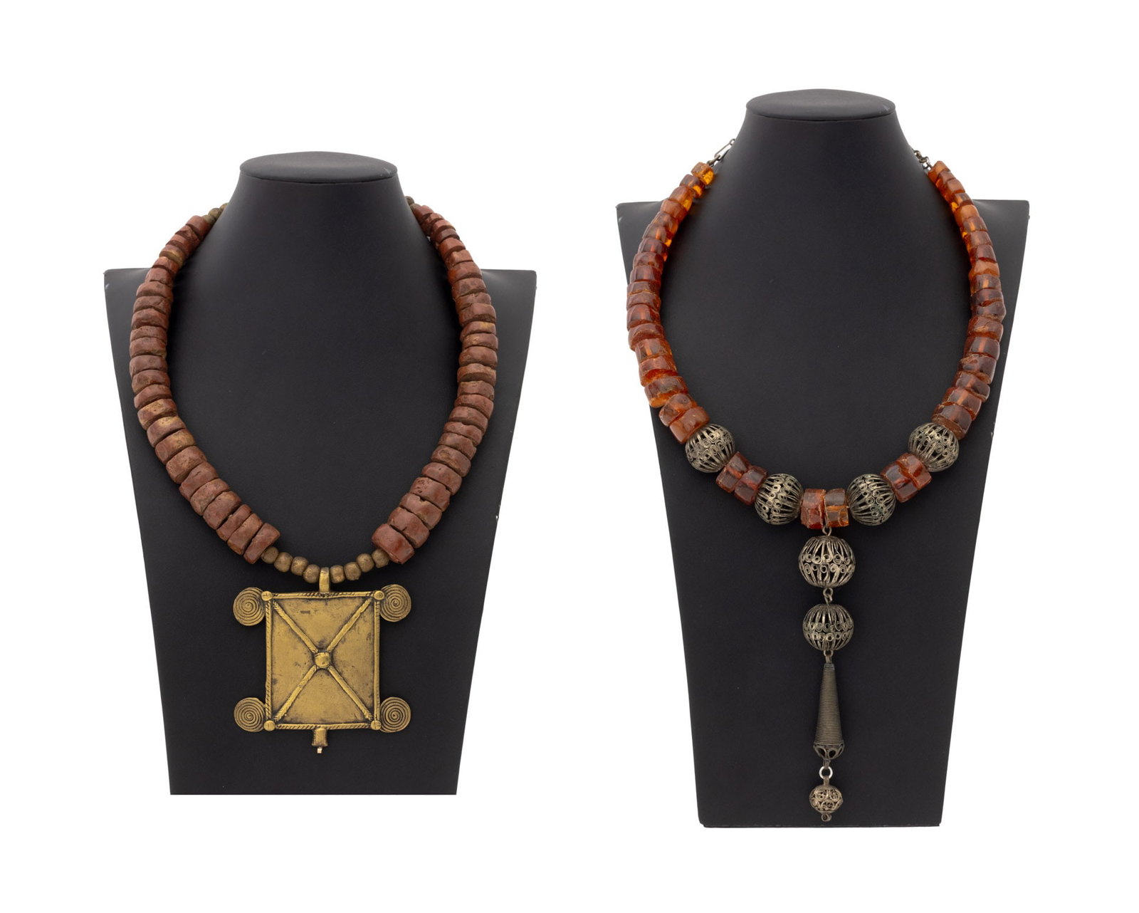 Irena Corwin Art Jewelry Necklaces, 2: Irena Corwin (American, XX) Group of Two Art Jewelry Necklaces, one with red jasper disc beads and African brass pendant and one with amber beads and metal filigree beads. Larger: 32" L x 4" W. Proven
