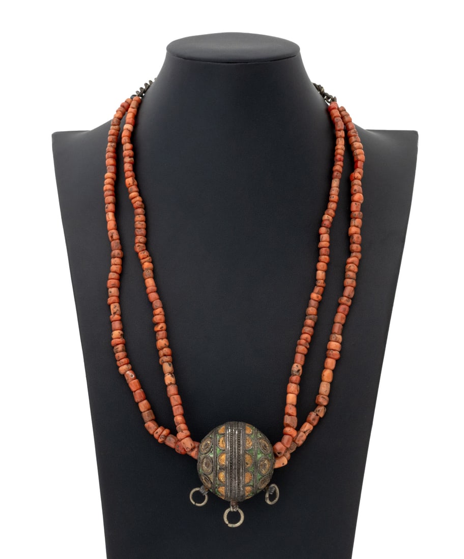 Moroccan Silver Tagmout and Red Coral Necklace: Moroccan Polychrome Enameled Silver Tagmout Pendant and Red Coral Beaded Necklace, worn as slip-over-the-head. Silver not weighable. 25.25" L x 2" W. Provenance: From the Estate of Jewelry Designer Ir