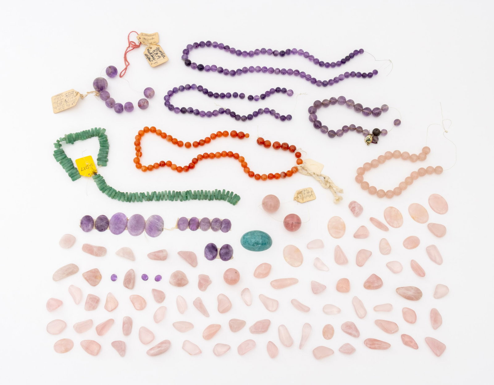 Collection of Crystal Cabochons and Beads: Collection of Crystal Cabochons and Beads, including: rose quartz, amethyst, amazonite, and carnelian. Largest cabochon: 2" H x 1.5" W x 1" D. Provenance: From the Estate of Jewelry Designer Irena